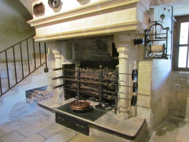We got to go downstairs into the huge kitchen area - a fascinating place. This fireplace served as a rotisserie - you can see the robes for turning whatever was on the spit on the right side of the fireplace.