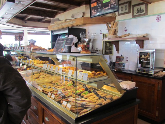 And at the other end of the store was this restaurant with lots of French (if course!) pastries and other great looking dishes that they would professionally heat for you. Through the back door you could even see the racks of their big ovens with pastries baking on them. And it smelled wonderful in there!