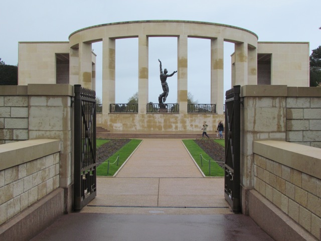 Looking through the Garden of the Missing at the Memorial featuring a 22-foot statue, "The Spirit of American Youth Rising from the Waves."
