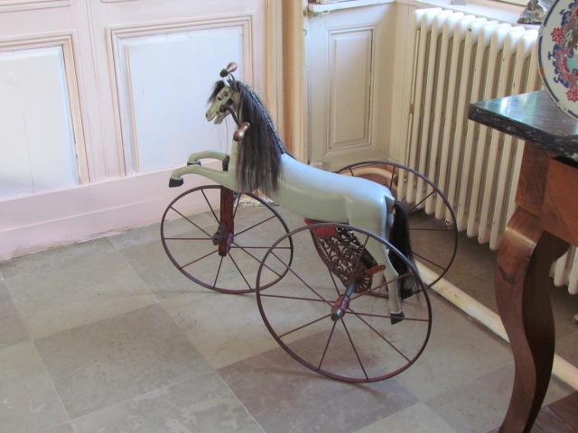 An antique rocking horse sat in the corner of the dining room.