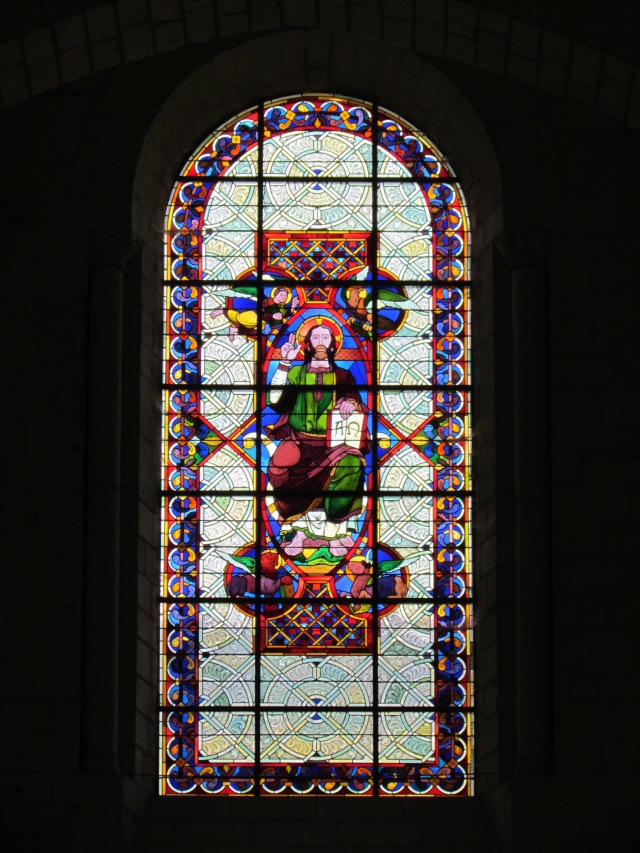 A beautiful stained glass window high over the front entry door.